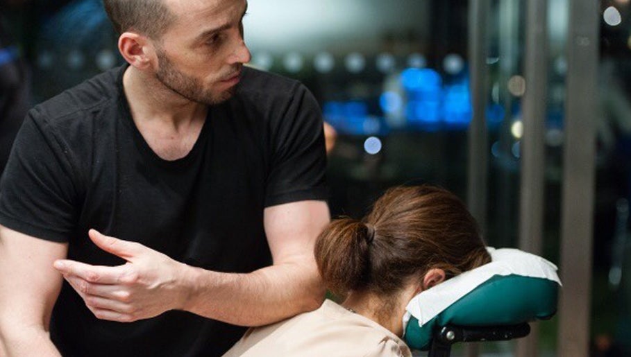 Therapist providing massage at X + Why Members - Chiswick Works in London, England, GB.