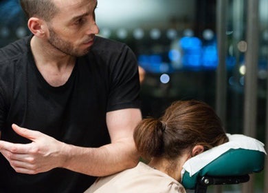 Therapist providing massage at X + Why Members - Chiswick Works in London, England, GB.