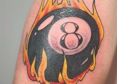 Tattoo of a flaming eight ball at Otzi Ink, Shipley, England, GB. Bold, creative tattoo design.