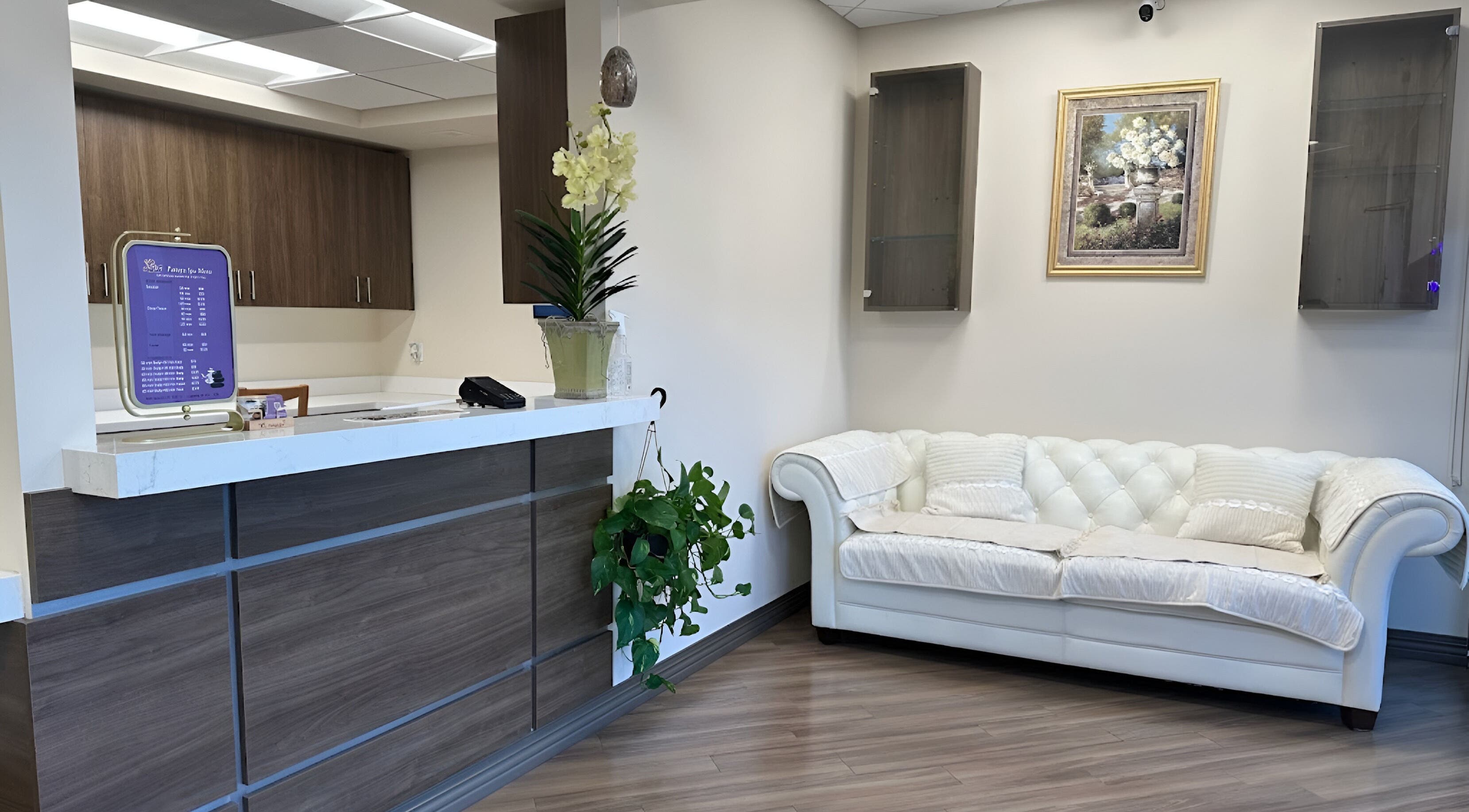 Relaxing lounge area at Pattaya Spa, Pembroke Pines, Florida, US featuring a white sofa and elegant decor.