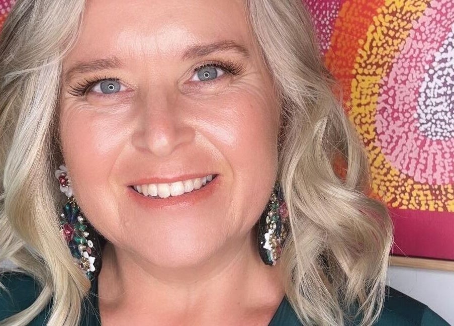 A smiling person with styled blonde hair at Illume Beauty @ Jennifer's Hair Salon, Wauchope, New South Wales, AU.