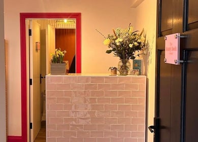 Reception area at Alexia Constantin Beauty in Hereford, England, GB, featuring elegant floral decor.