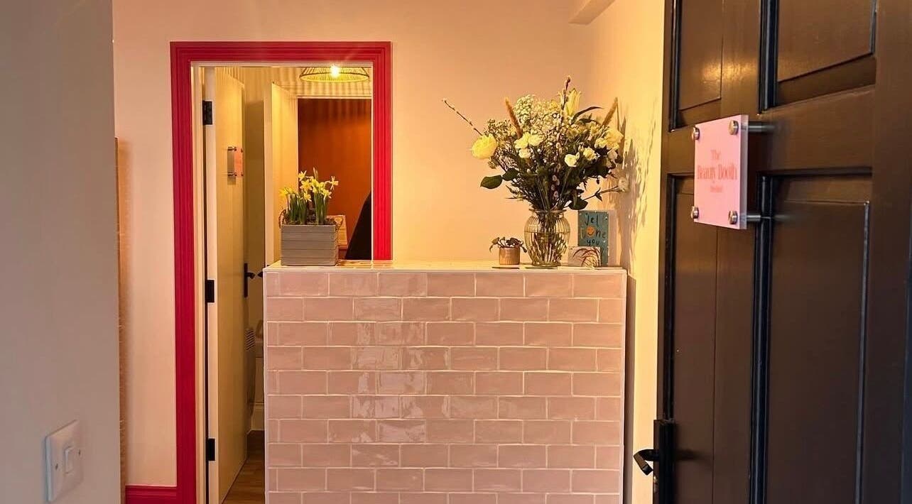 Reception area at Alexia Constantin Beauty in Hereford, England, GB, featuring elegant floral decor.