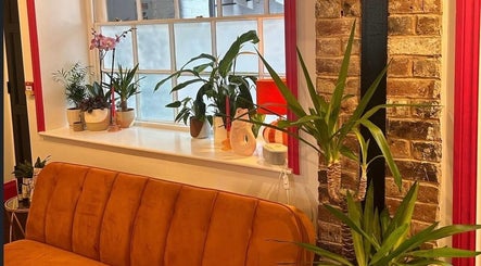 Warm lounge area with plants at Alexia Constantin Beauty, Hereford, England, GB.