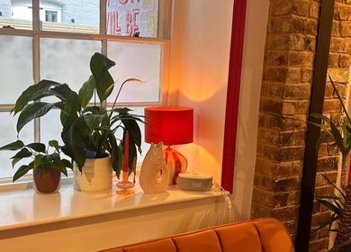 Warm interior with plants and orange lamp at Alexia Constantin Beauty, Hereford, England, GB.