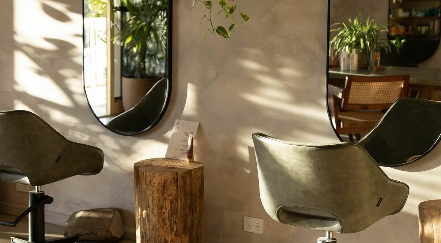 Modern salon interior at Hair by Gill in Burleigh Heads, Queensland, AU with stylish mirrors and chairs.