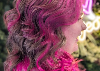 Colorful hair design at Pamela Connor, Dundee, Scotland, GB, showcasing vibrant pink highlights.