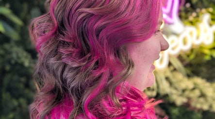Colorful hair design at Pamela Connor, Dundee, Scotland, GB, showcasing vibrant pink highlights.