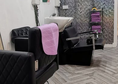Elegant salon seating and basin at This Is It in Dundee, Scotland, GB, highlighting sleek design and comfort.