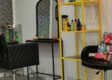 Chic salon corner at This Is It, Dundee, Scotland, GB, featuring modern hair products and vibrant decor.