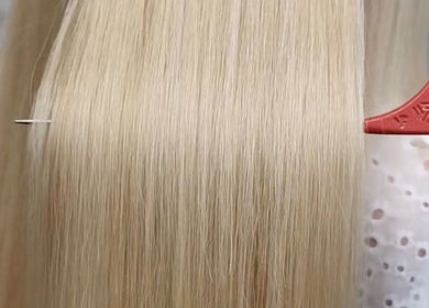 Blonde hair close-up with comb at This Is It salon in Dundee, Scotland, GB.