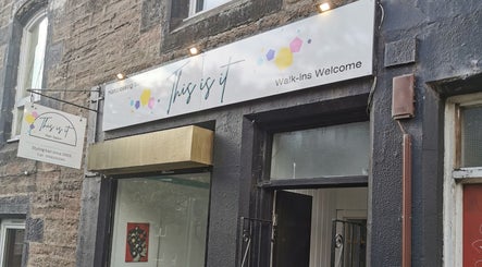 Front view of 'This Is It' hair salon in Dundee, Scotland, GB with welcoming signage.