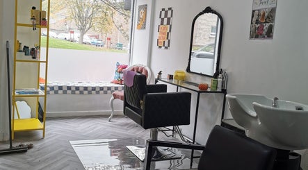 Modern beauty salon interior at This Is It, Dundee, Scotland, GB with styling chair and wash basin.