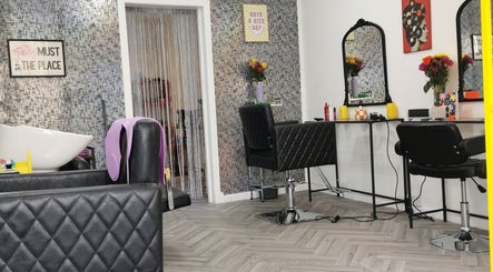 Elegant salon setup at This Is It, Dundee, Scotland, GB, featuring modern styling chairs and mirrors.