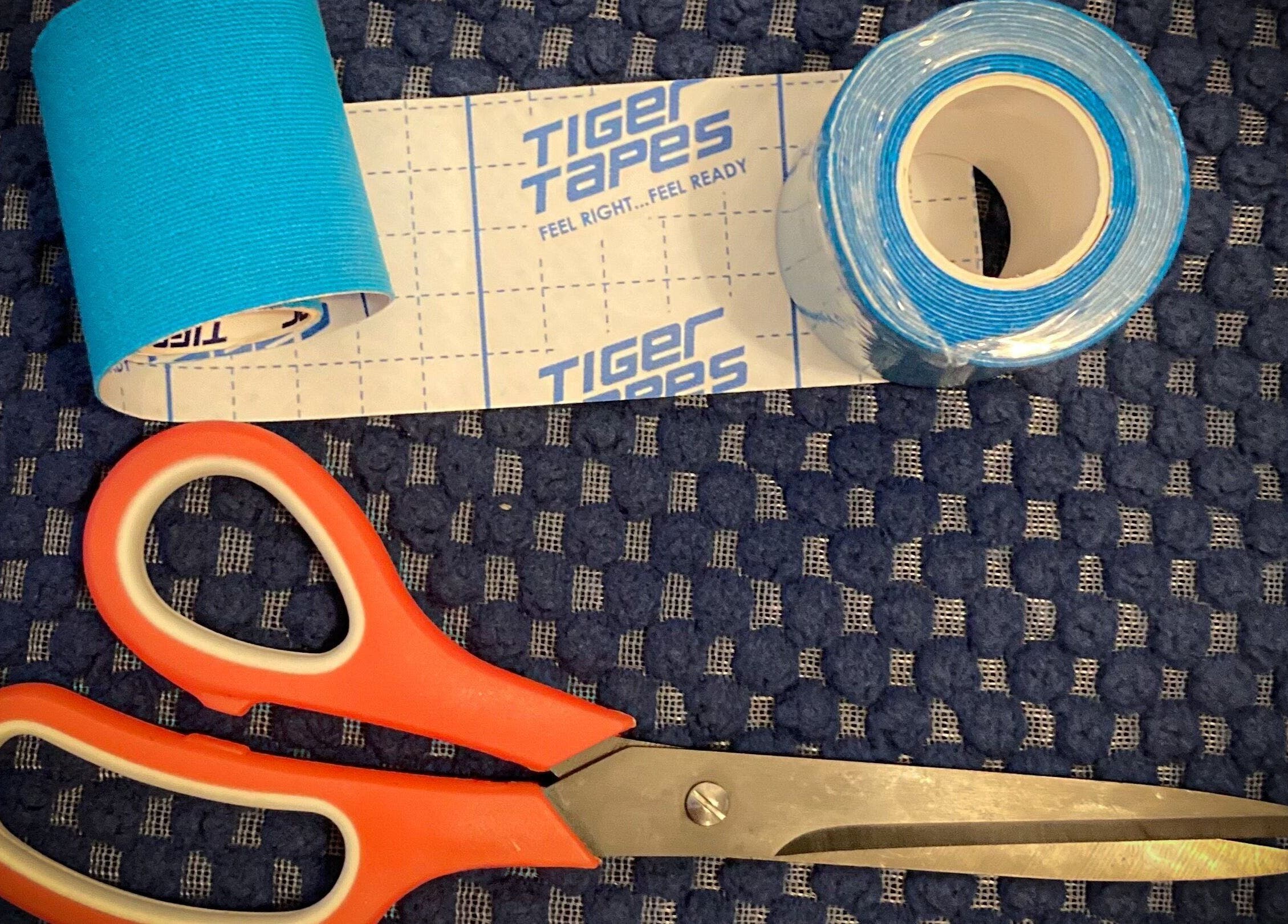 Blue kinesiology tape and scissors at Hughes Massage Therapy, Sleaford, England, GB.