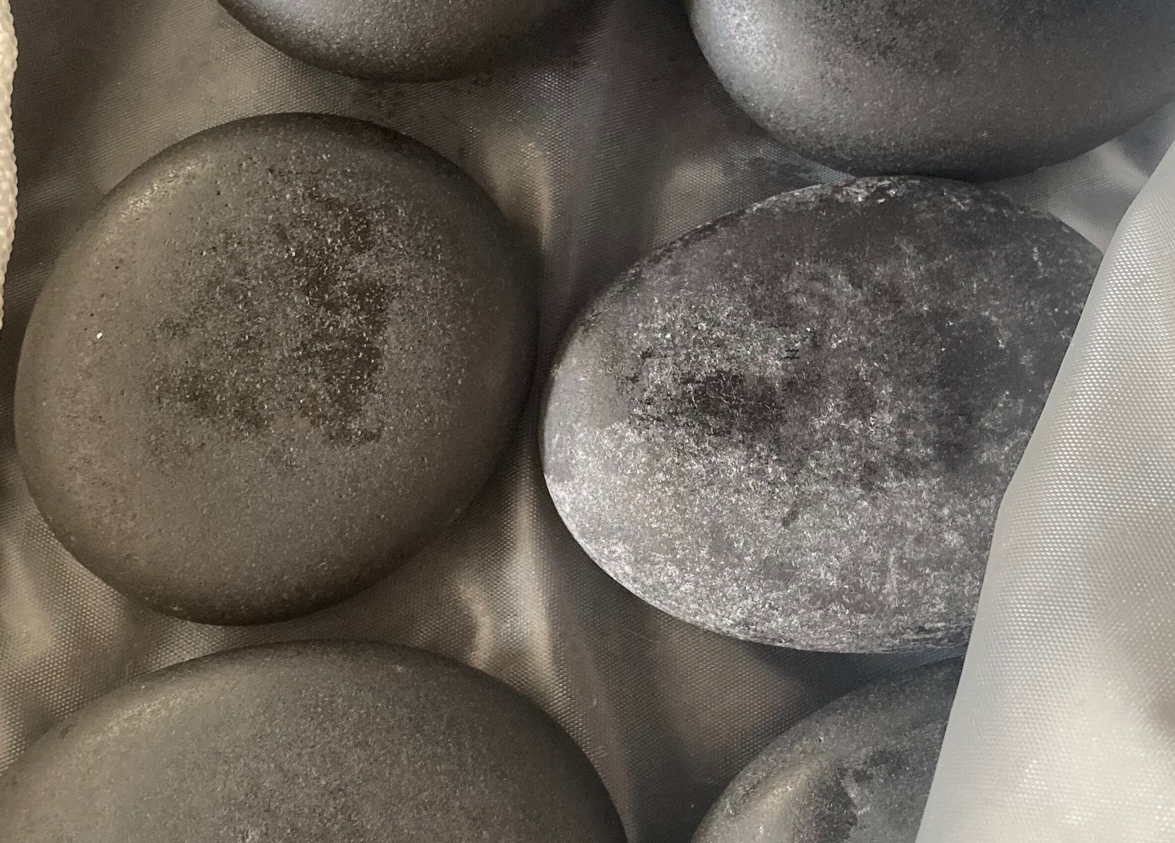 Hot stone set at Hughes Massage Therapy, Sleaford, England, GB, enhancing relaxation and wellness.