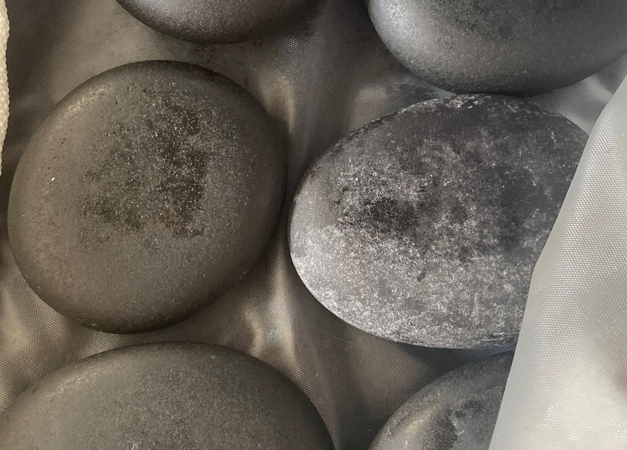 Hot stone set at Hughes Massage Therapy, Sleaford, England, GB, enhancing relaxation and wellness.