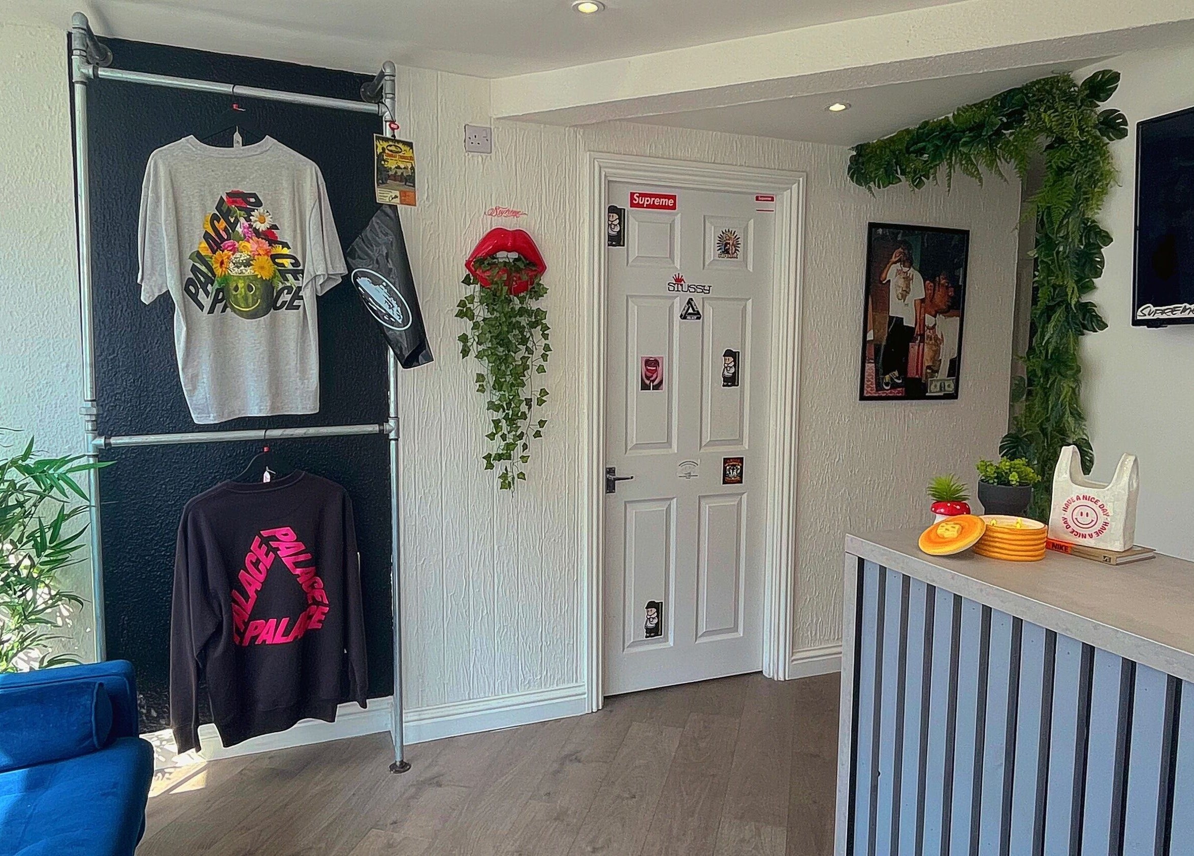 Stylish decor at Element 85 Barbers in Leven, Scotland, GB with modern attire and greenery accents.