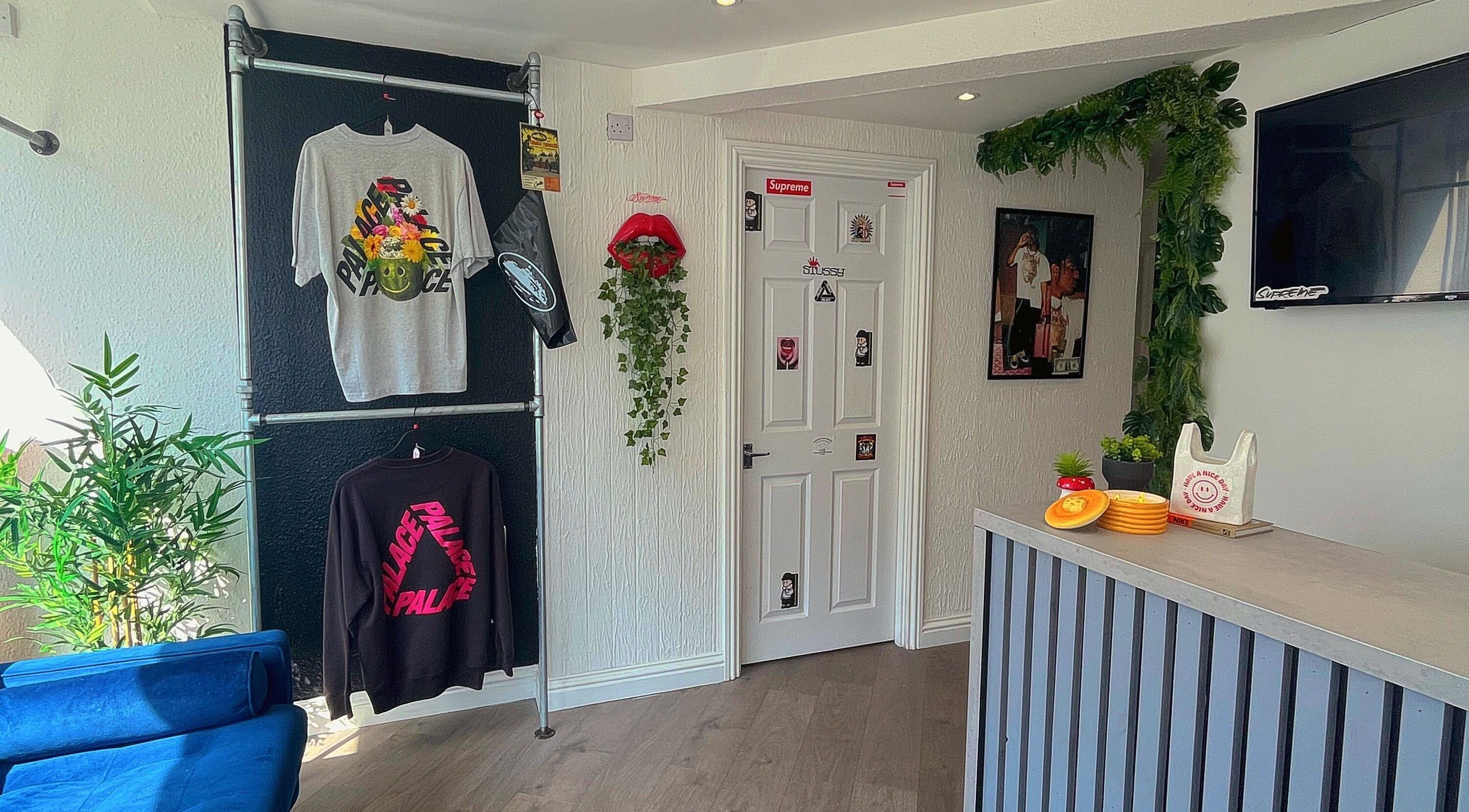 Stylish decor at Element 85 Barbers in Leven, Scotland, GB with modern attire and greenery accents.