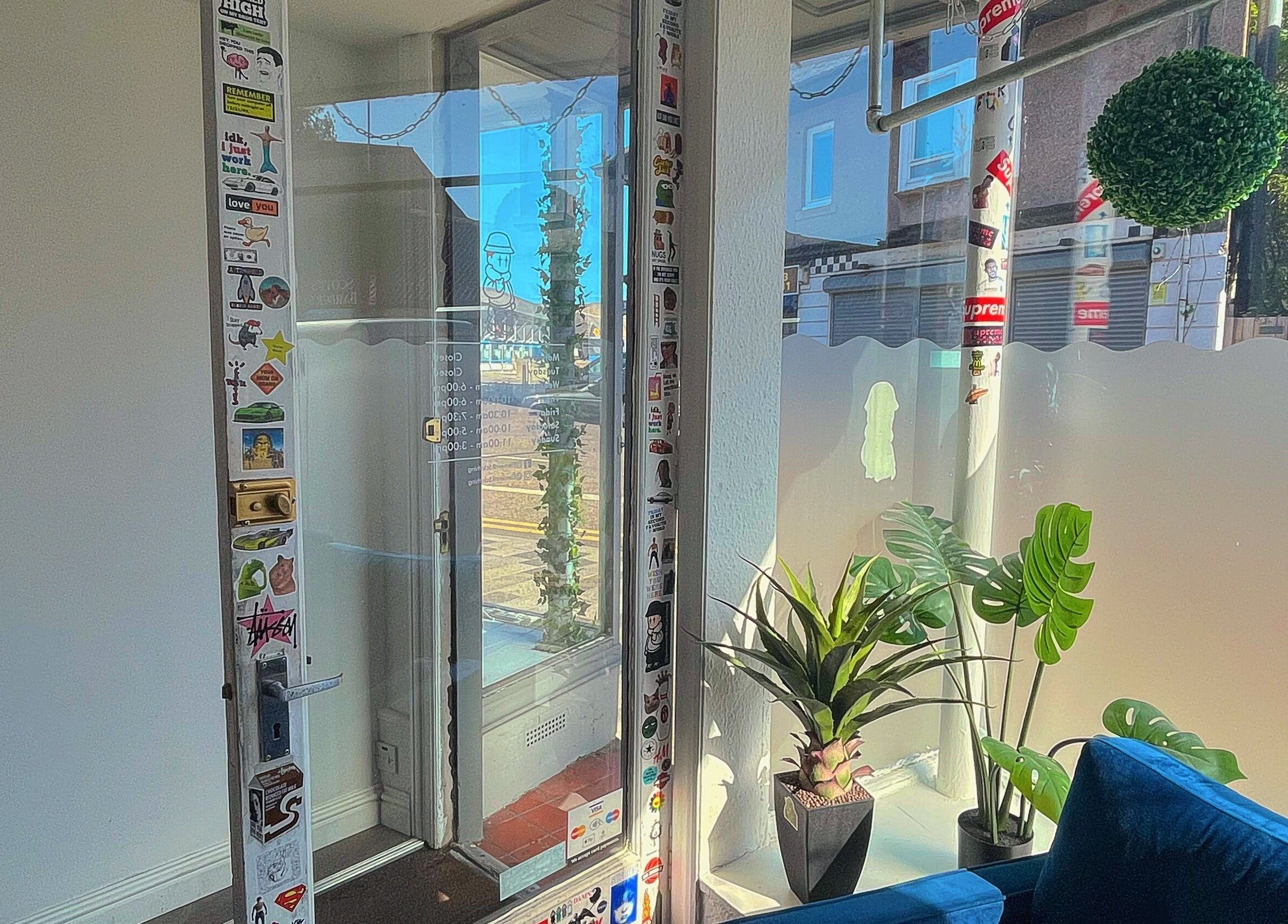 Entrance of Element 85 Barbers in Leven, Scotland, GB, with glass door and minimalist decor.