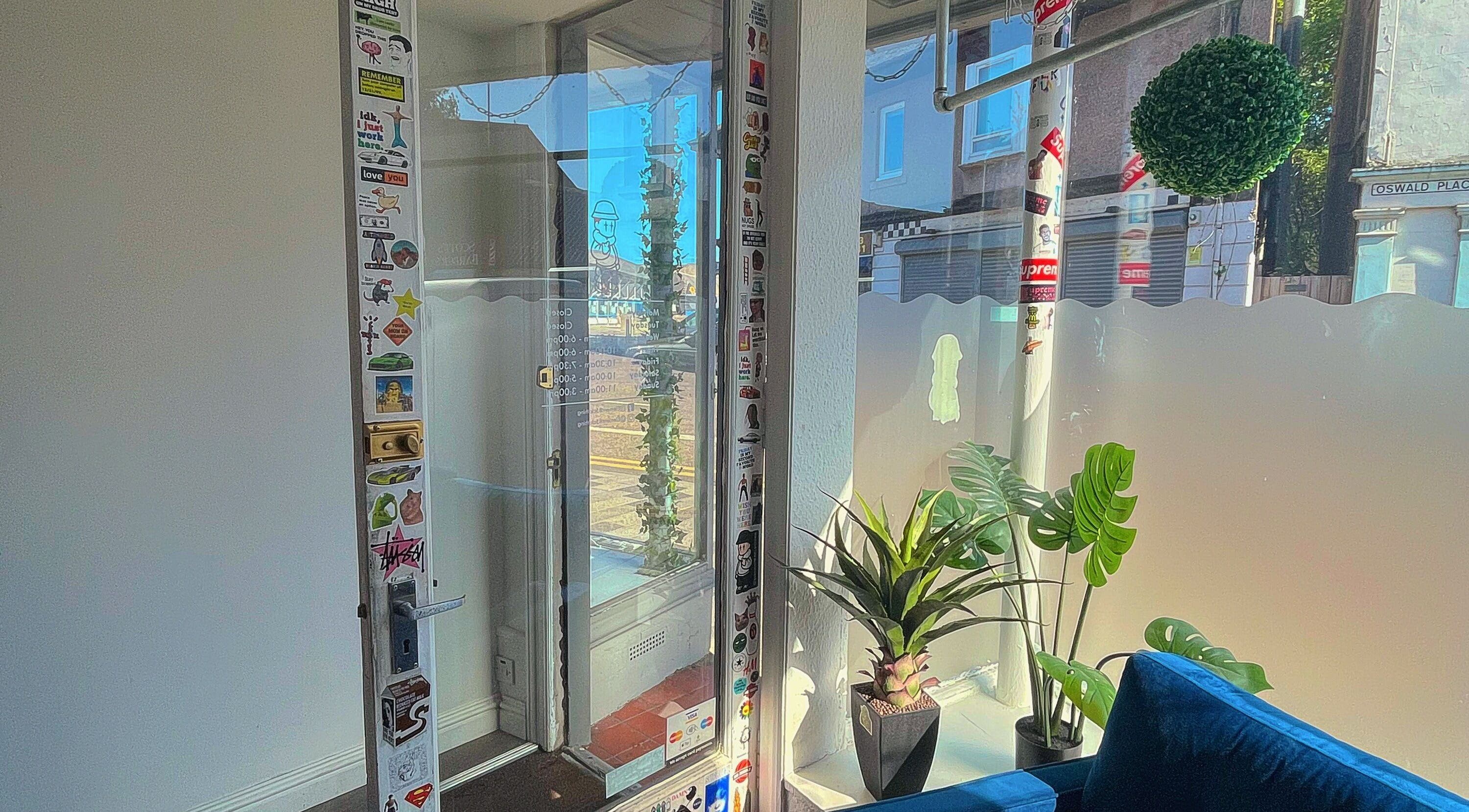 Entrance of Element 85 Barbers in Leven, Scotland, GB, with glass door and minimalist decor.