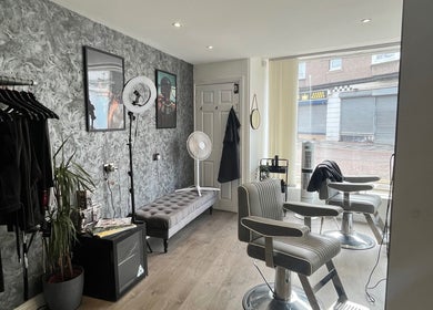 Modern interior of Element 85 Barbers in Leven, Scotland, GB with stylish chairs and elegant decor.