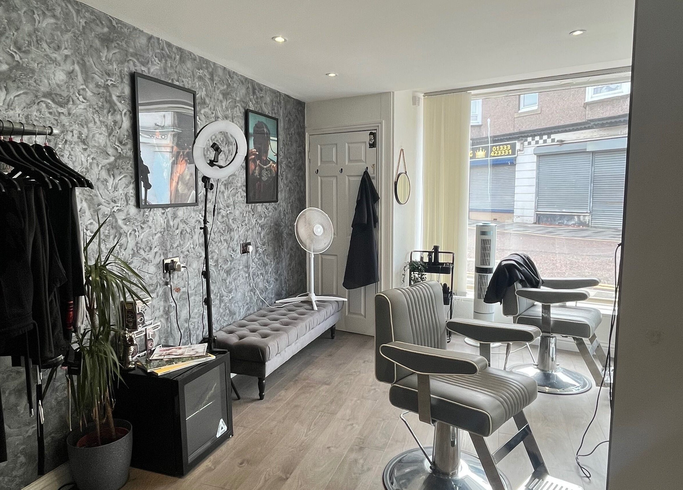 Modern interior of Element 85 Barbers in Leven, Scotland, GB with stylish chairs and elegant decor.