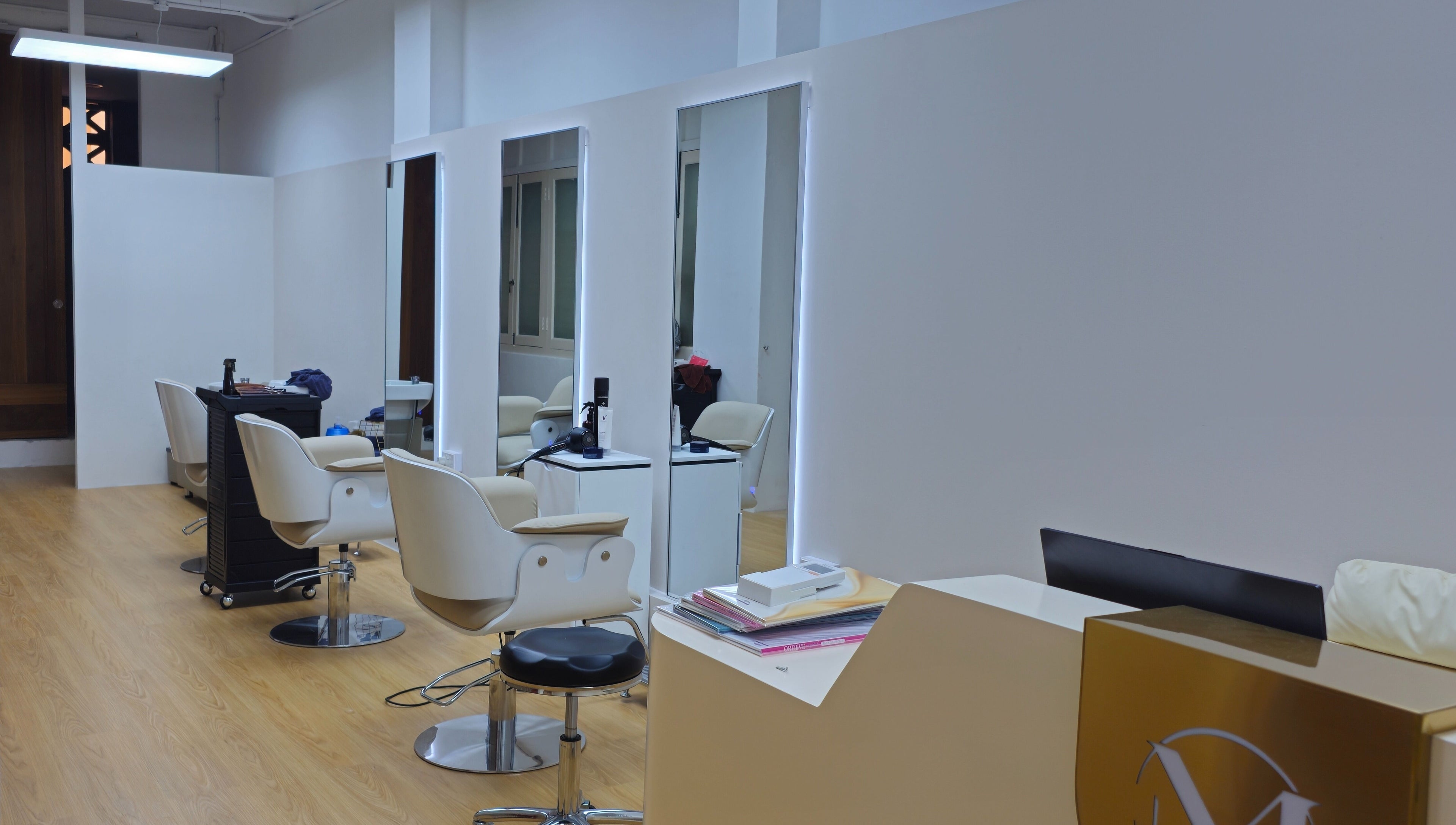 Modern salon interior at M.Y Refresh HairLab, Singapore, SG, featuring stylish chairs and mirrors.