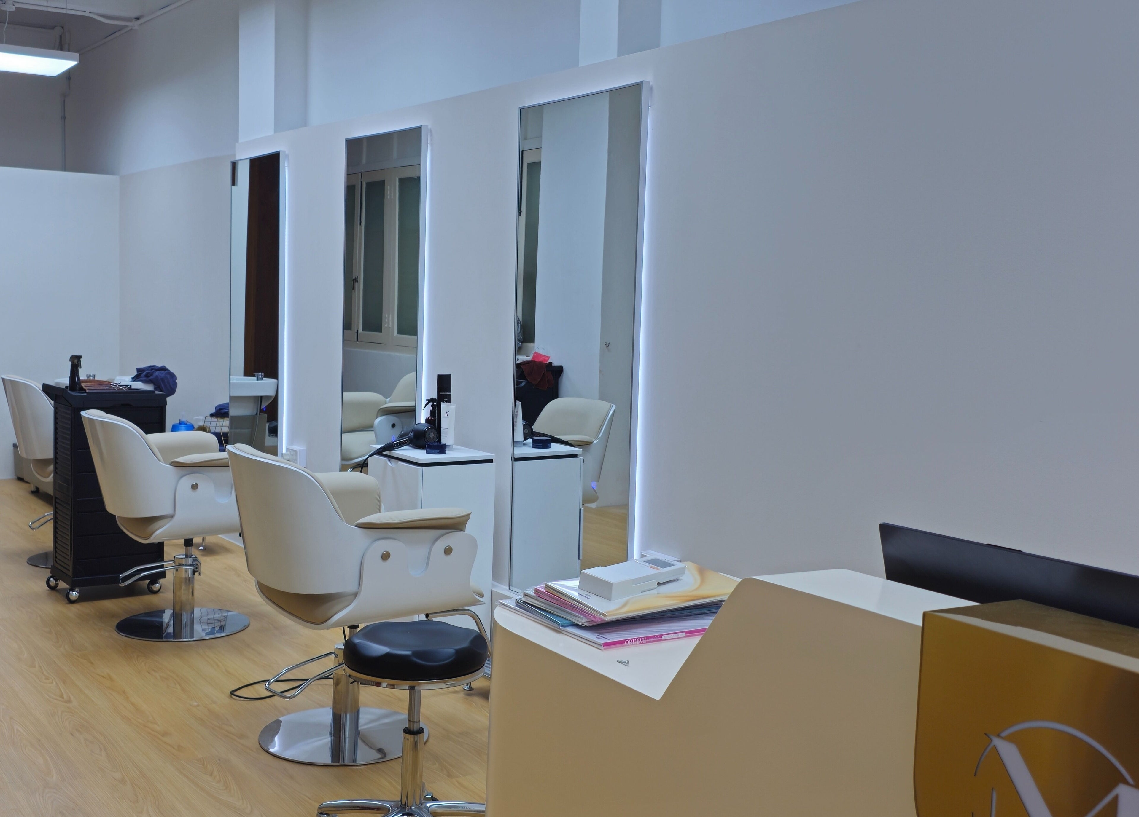 Modern salon interior at M.Y Refresh HairLab, Singapore, SG, featuring stylish chairs and mirrors.