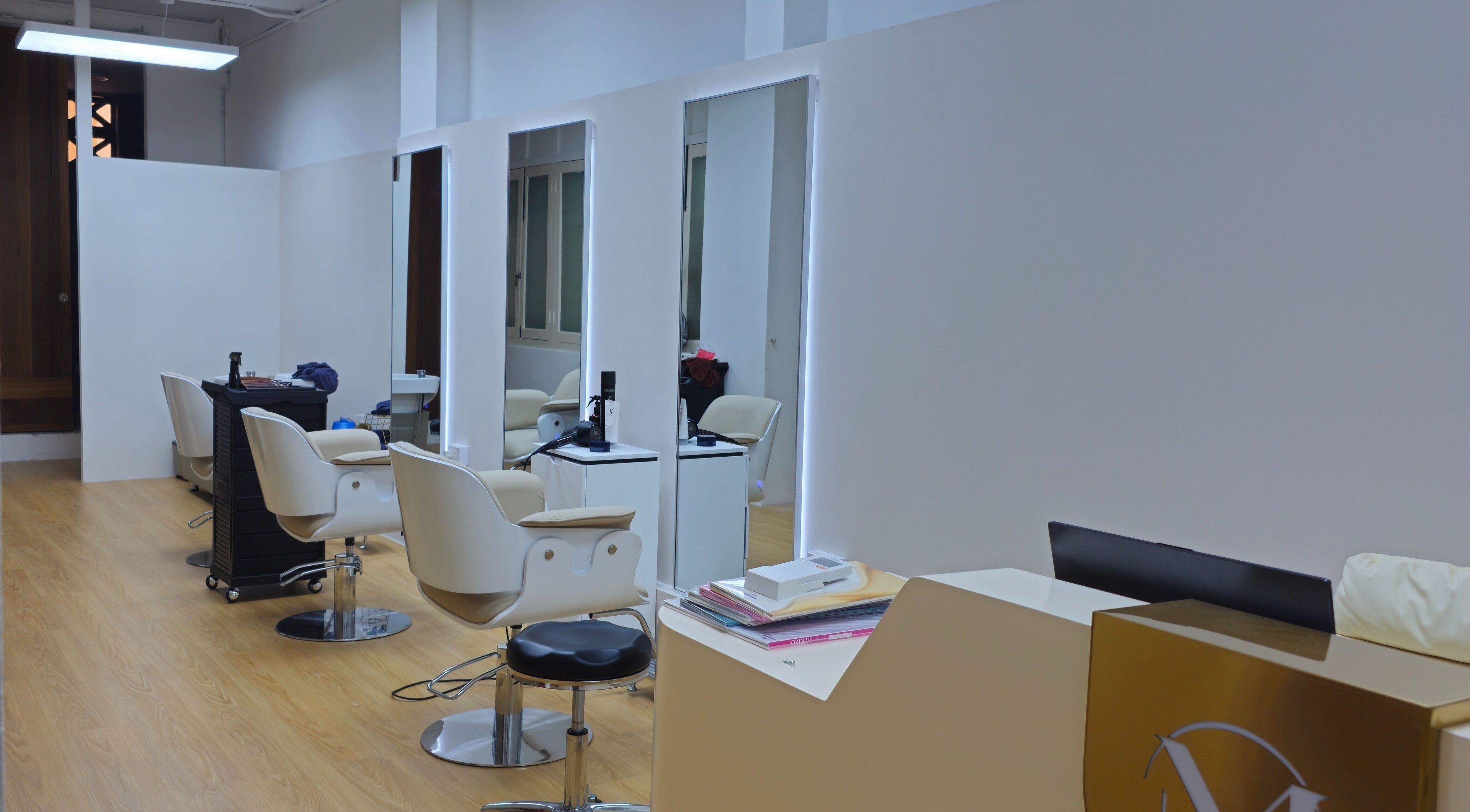 Modern salon interior at M.Y Refresh HairLab, Singapore, SG, featuring stylish chairs and mirrors.