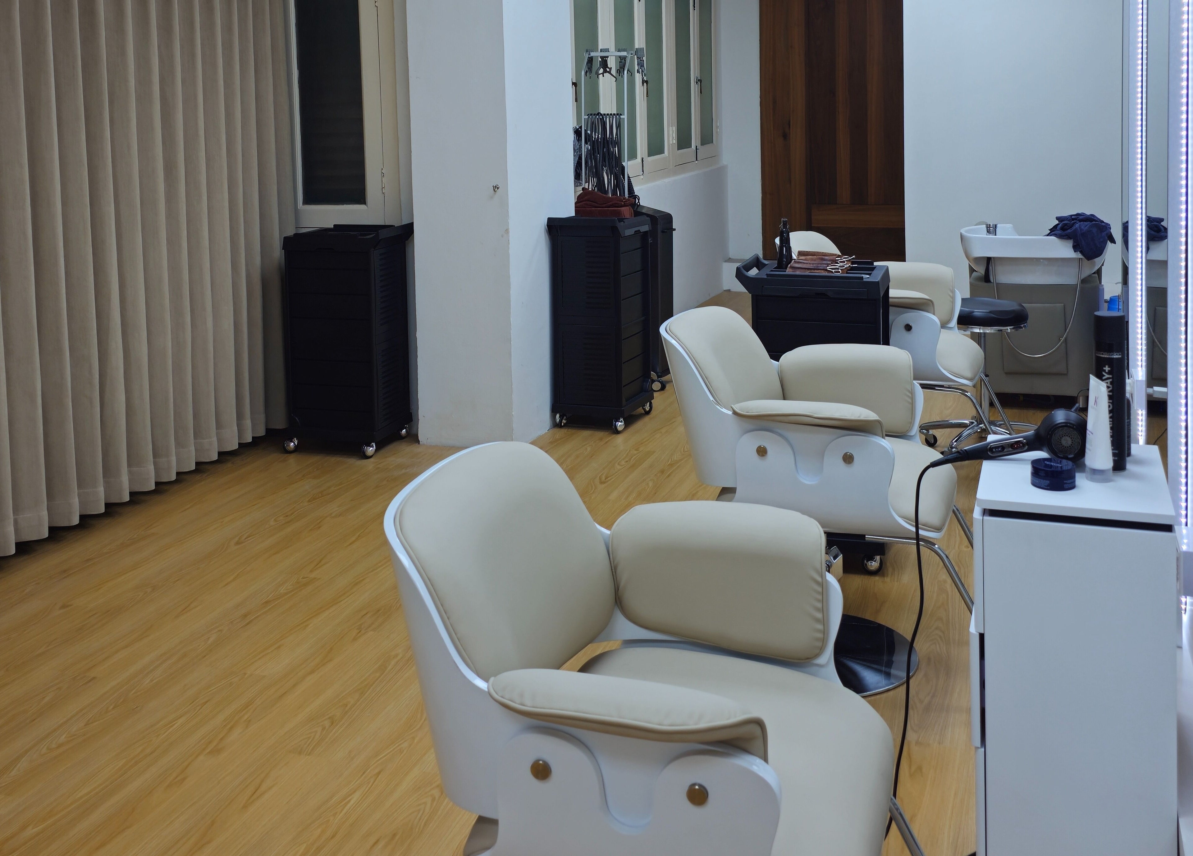 Modern salon interior at M.Y Refresh HairLab, Singapore, SG featuring chic chairs and styling stations.