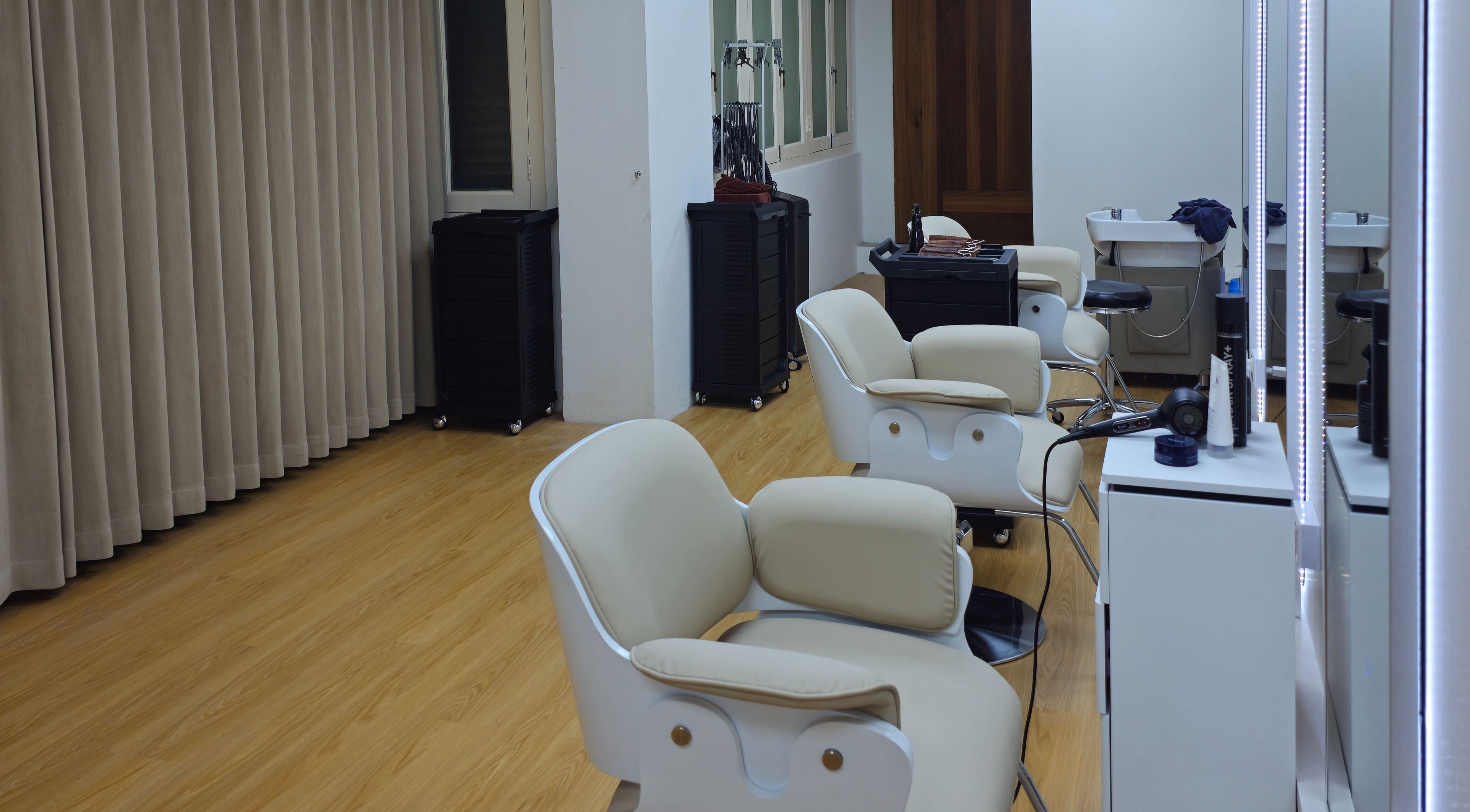 Modern salon interior at M.Y Refresh HairLab, Singapore, SG featuring chic chairs and styling stations.