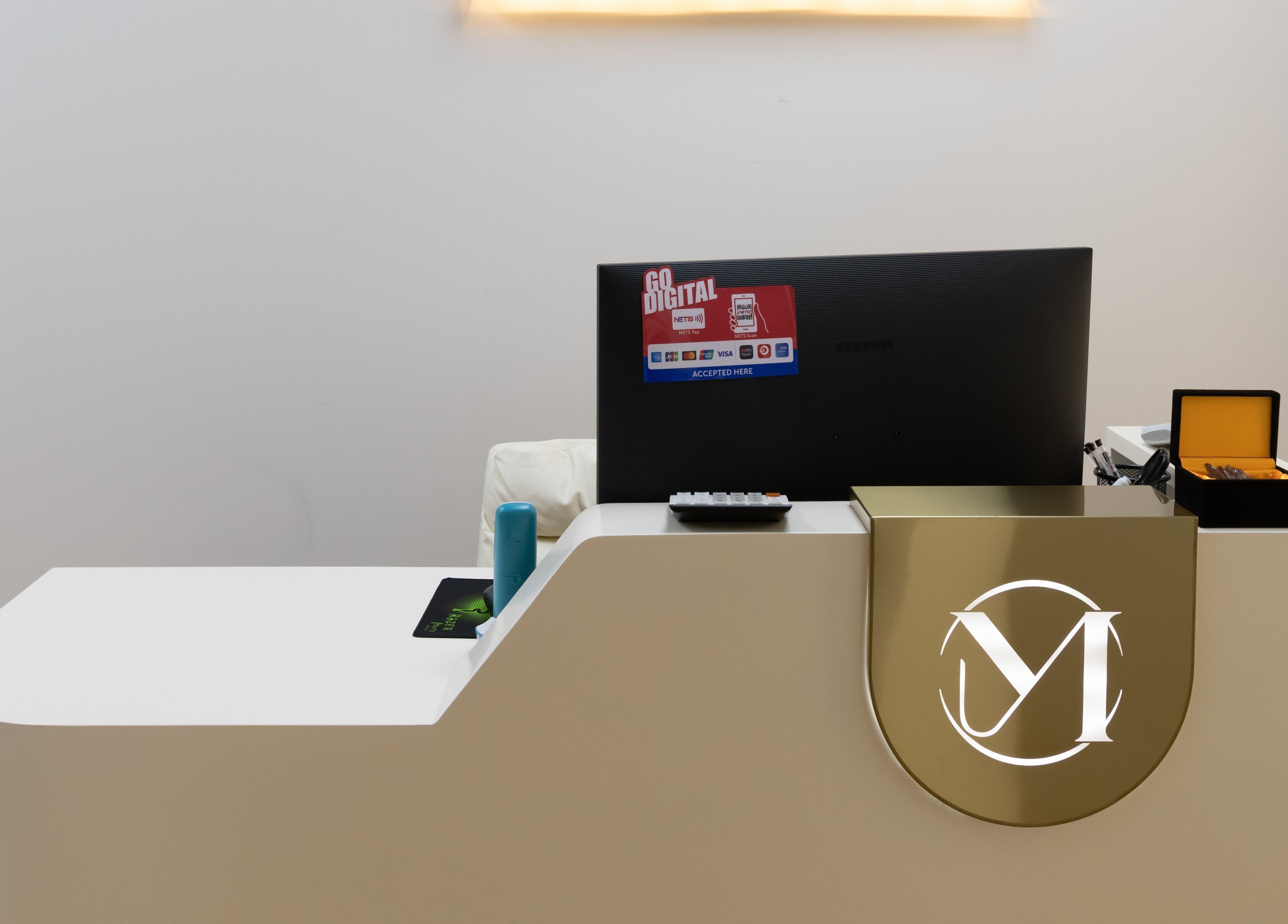 Elegant reception at M.Y Refresh HairLab in Singapore, SG, with a modern desk and digital signage.