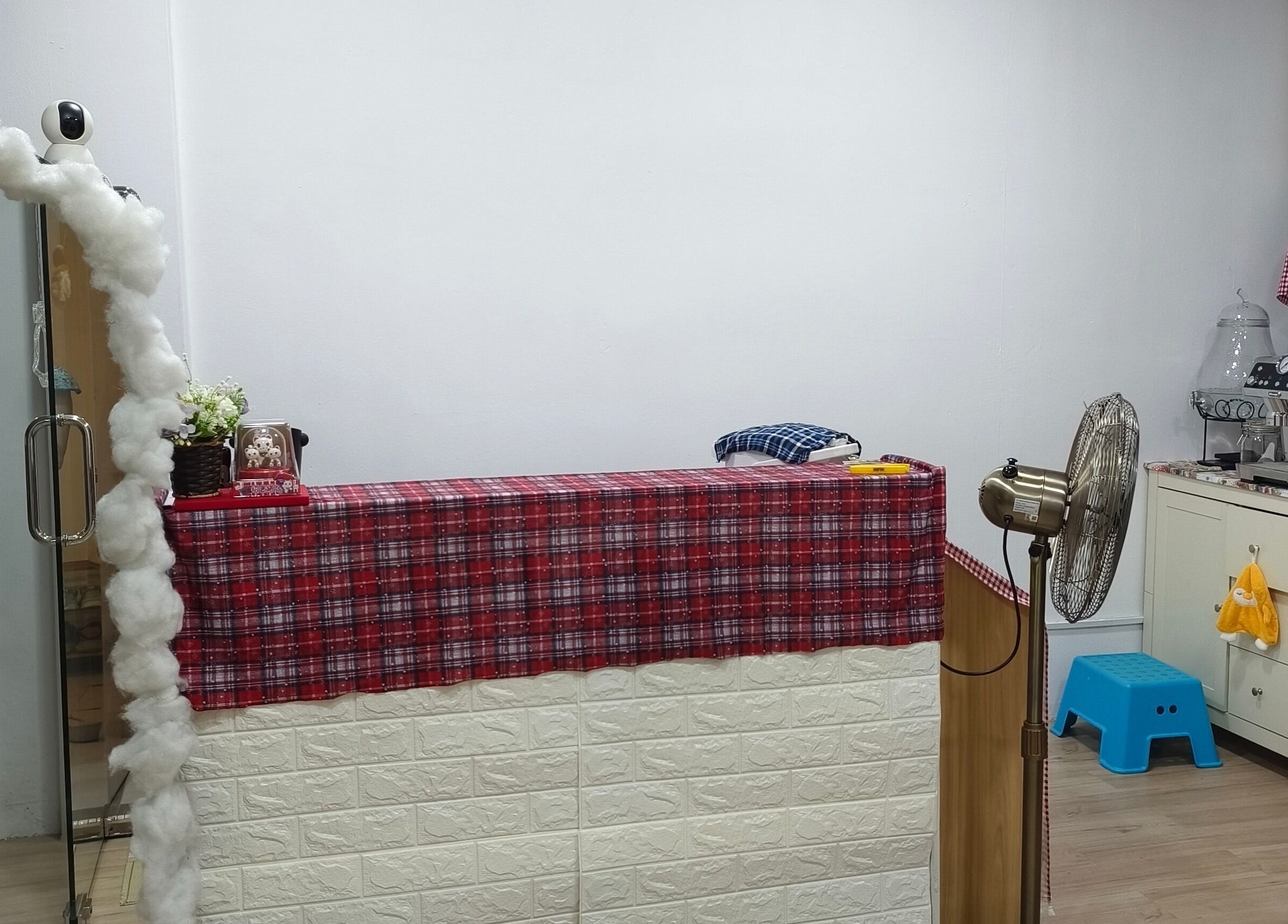 Reception area of Rainbow Nail Spa in Subang Jaya, Selangor, MY with red plaid decor and cozy elements.
