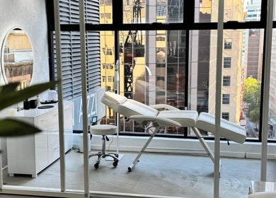 Luxurious treatment room at Edge Brows in Sydney, New South Wales, AU with city views.