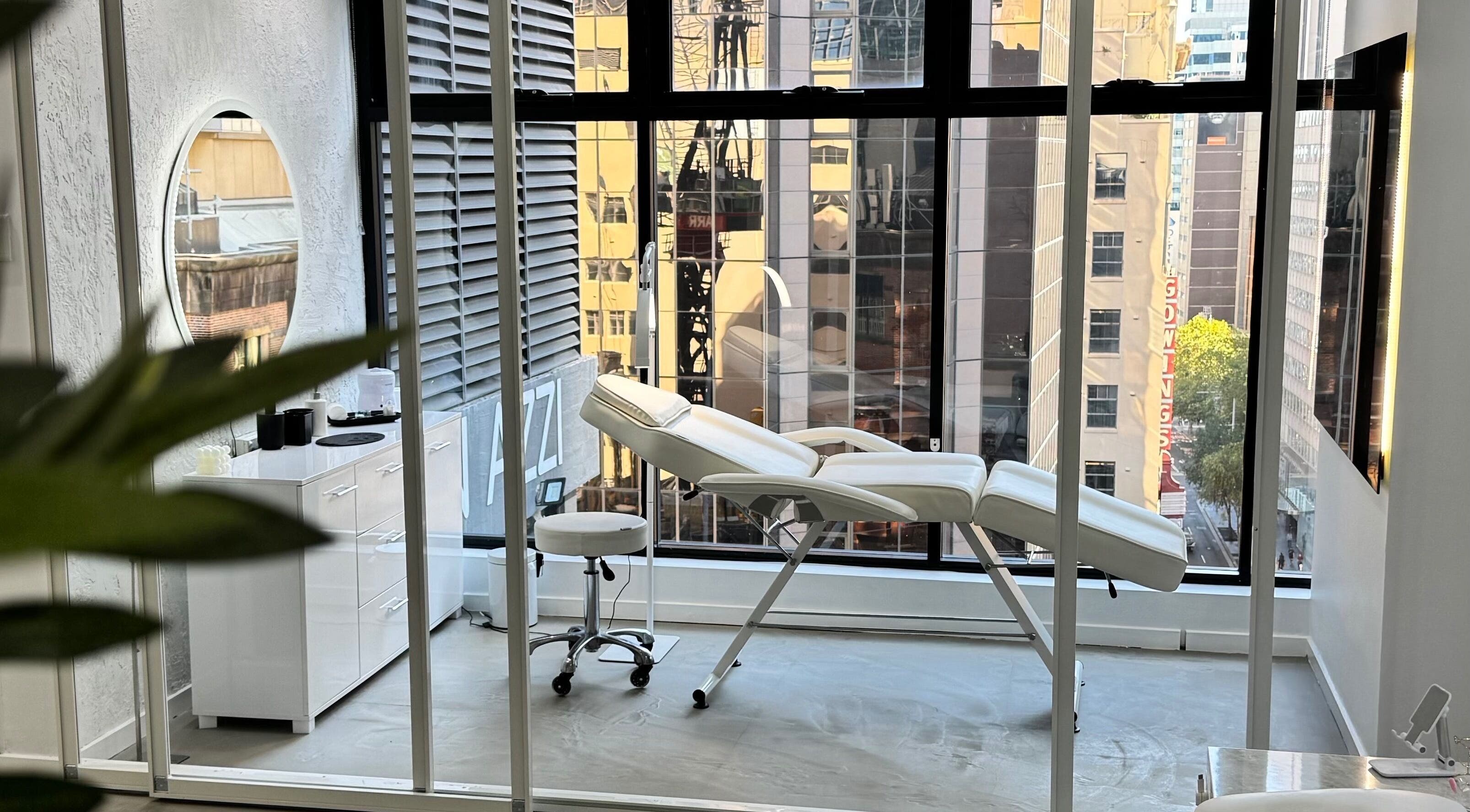 Luxurious treatment room at Edge Brows in Sydney, New South Wales, AU with city views.