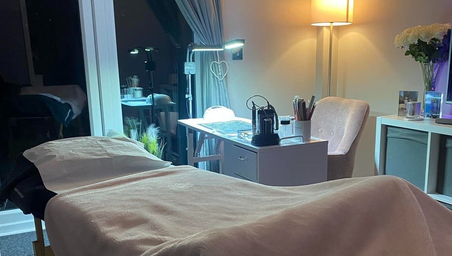 Tranquil spa treatment room at Becky in Frimley Green, England, GB featuring a cozy massage bed.