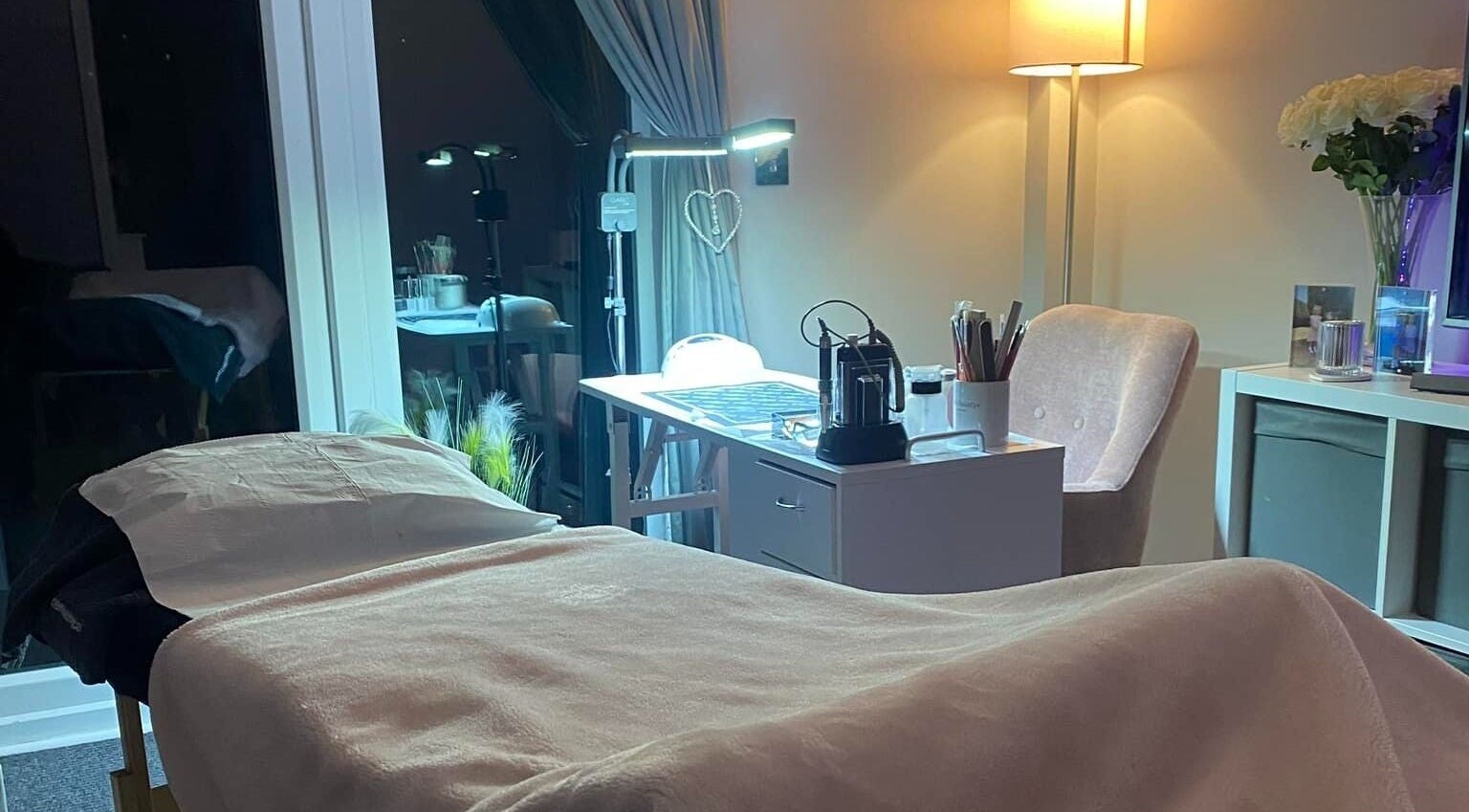 Tranquil spa treatment room at Becky in Frimley Green, England, GB featuring a cozy massage bed.