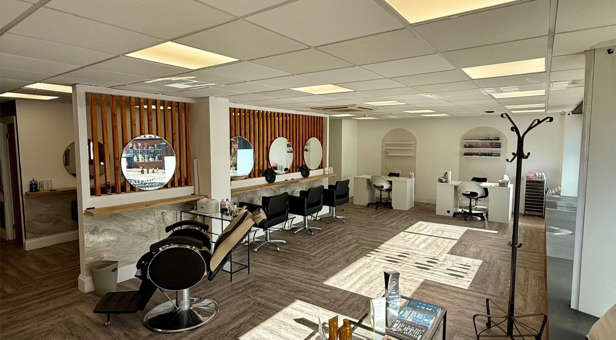 Modern interior of Gemma Louise Hair & Beauty in Blyth, England, GB featuring sleek styling stations and elegant decor.