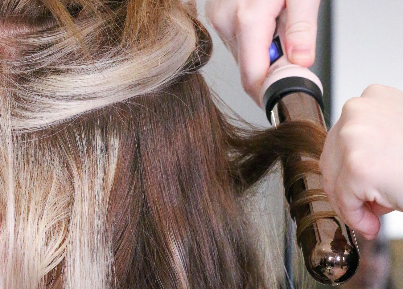 Hair styling with curling iron at Bella Vida Head Spa, Bowmanville, Ontario, CA.