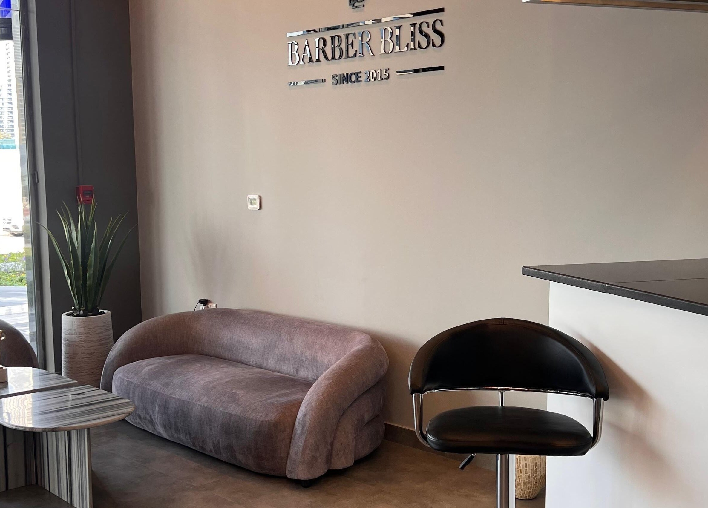 Elegant lounge area at Barber Bliss L.L.C, Dubai, Dubai, AE with sleek furniture and modern decor.