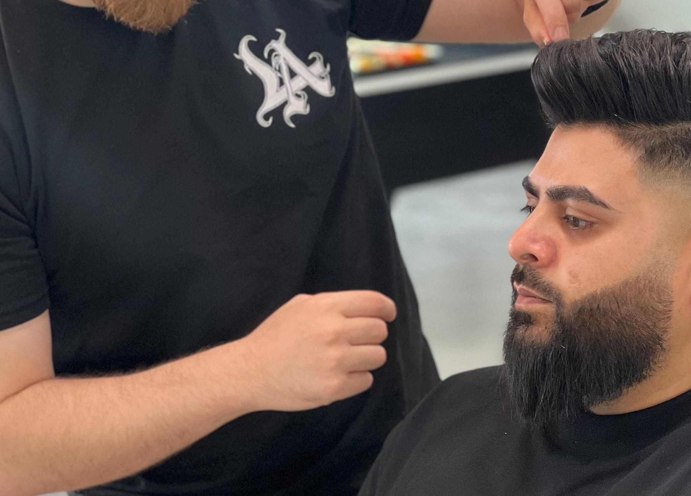 Barber Bliss L.L.C stylist perfecting a haircut in Dubai, Dubai, AE. Modern grooming at its finest.