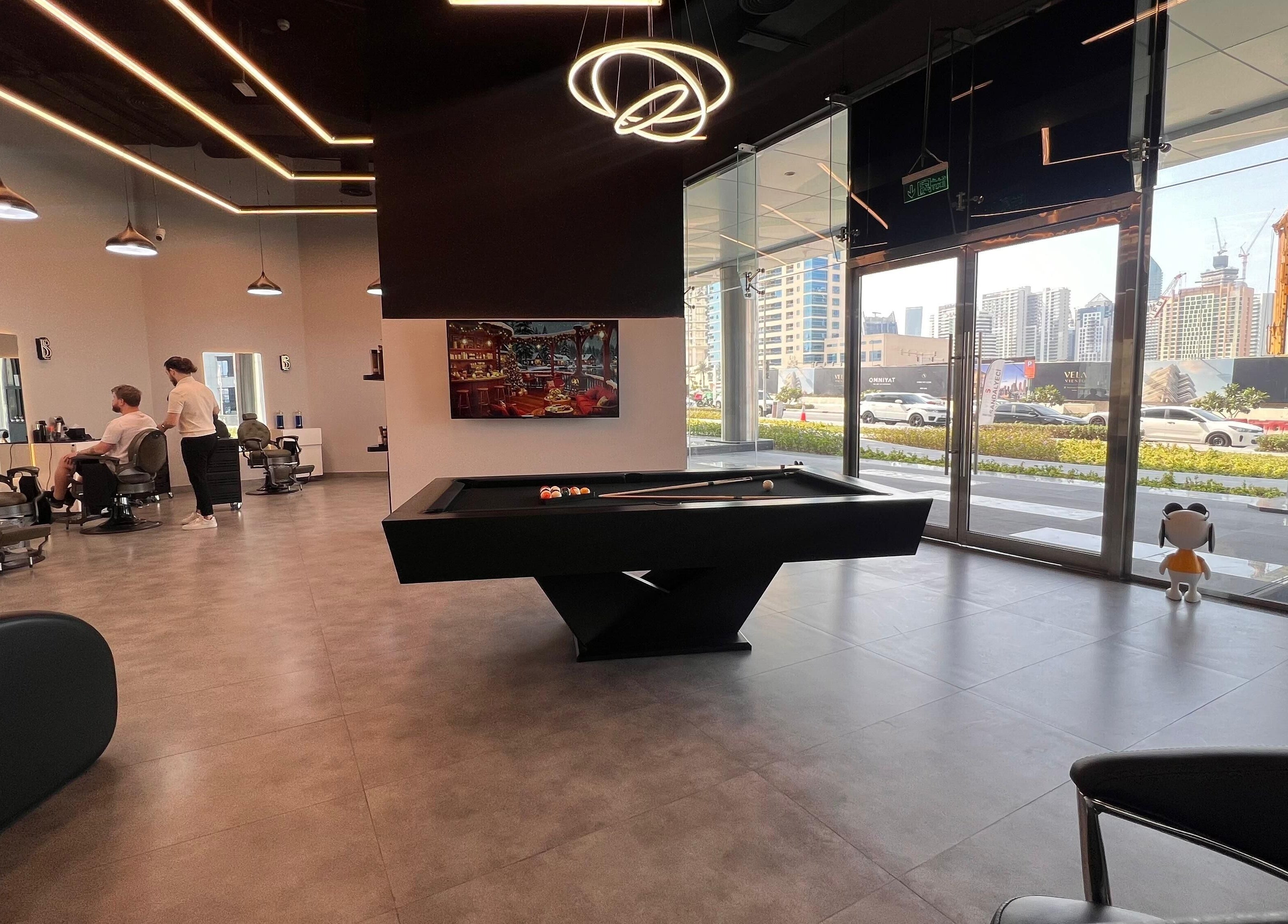 Luxurious interior of Barber Bliss L.L.C in Dubai, Dubai, AE showcasing modern chairs and a pool table.