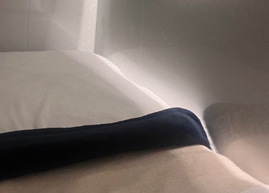 Relaxing massage table at Hushed Beauty in Glasgow, Scotland, GB, draped with a plush towel.