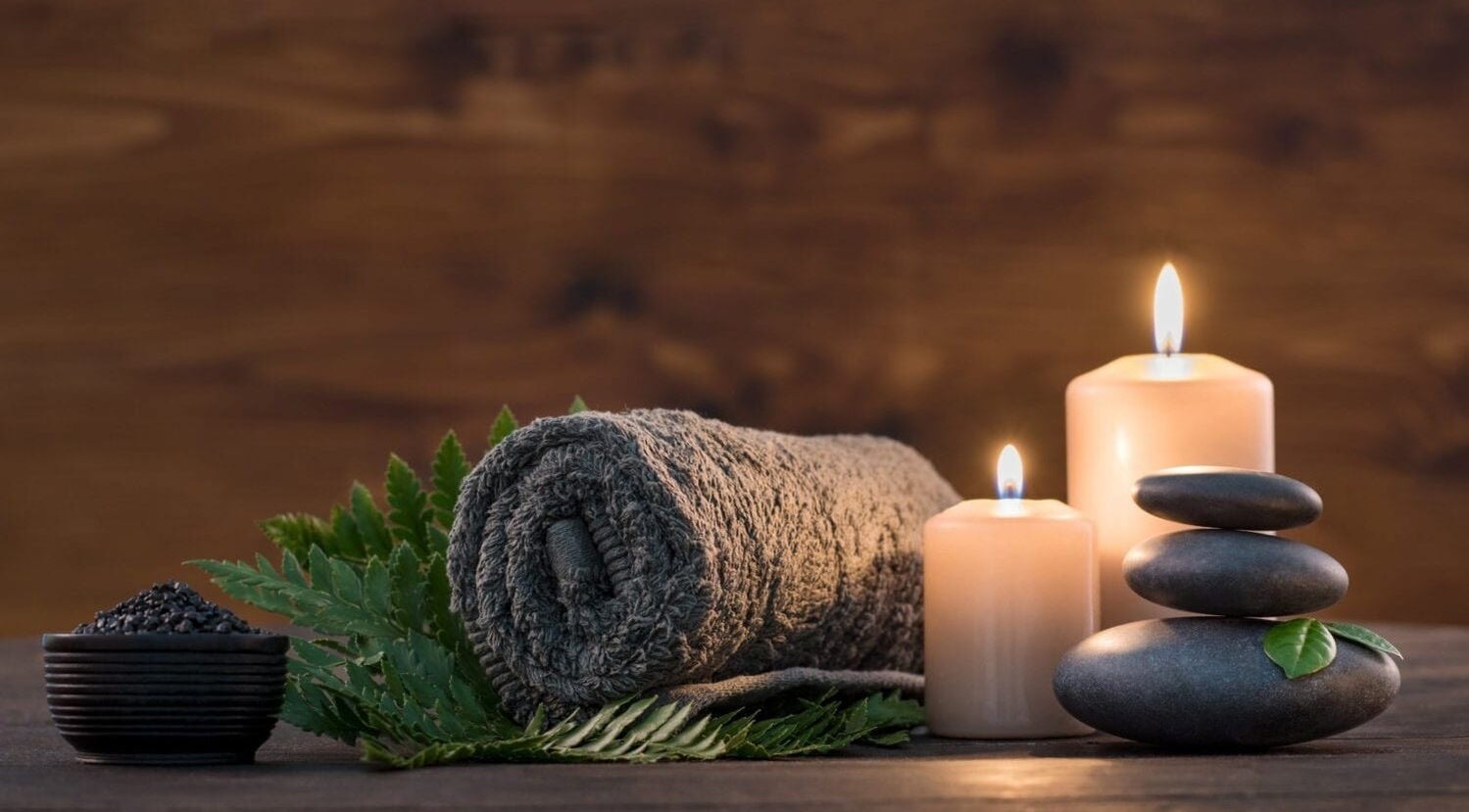 Relaxing spa scene at Luna Rose Holistic & Beauty Therapy in Loughborough, England, GB with candles and stones.