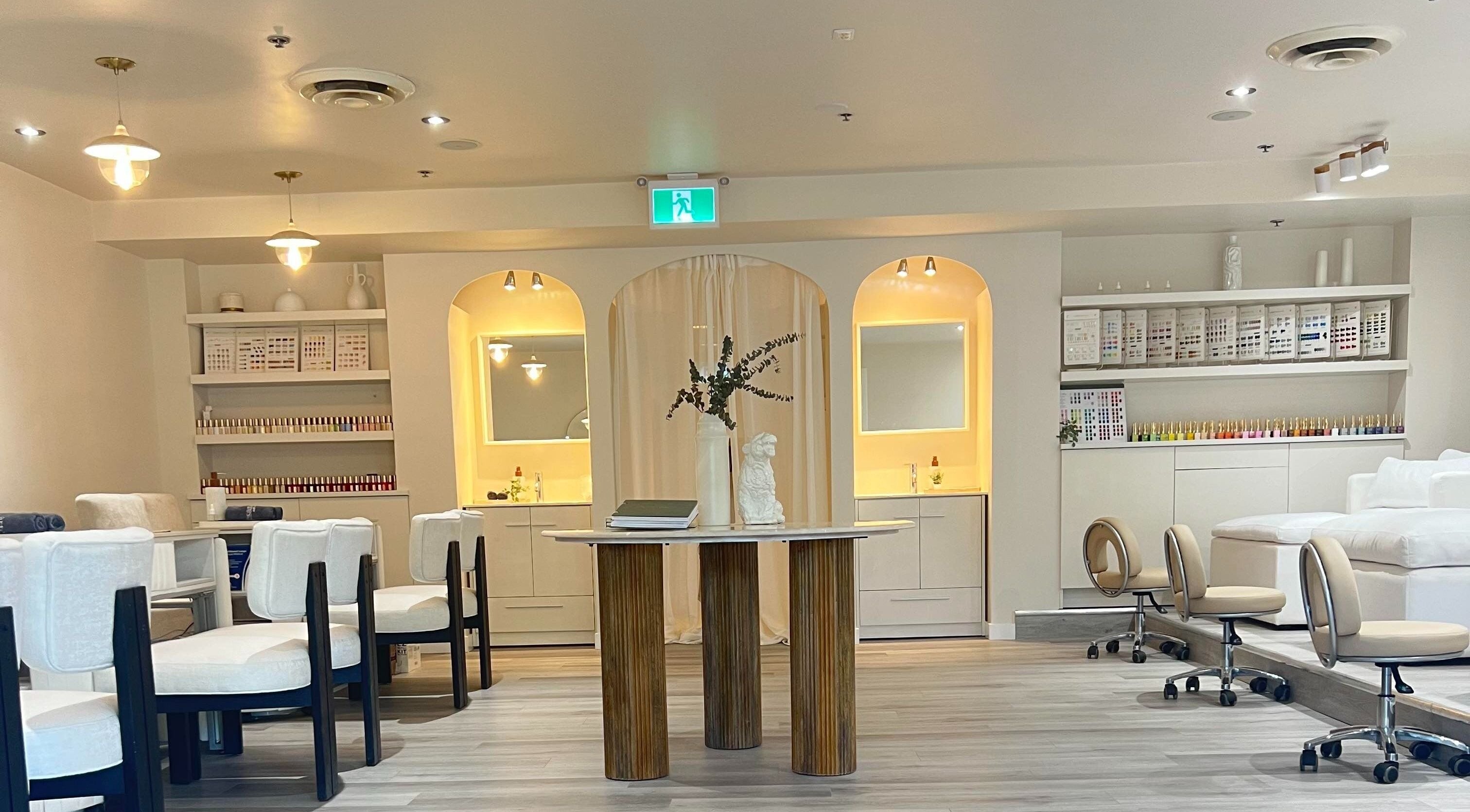 Elegant interior of Artesano Cafe and Nail in Vancouver, British Columbia, CA, featuring stylish seating and decor.