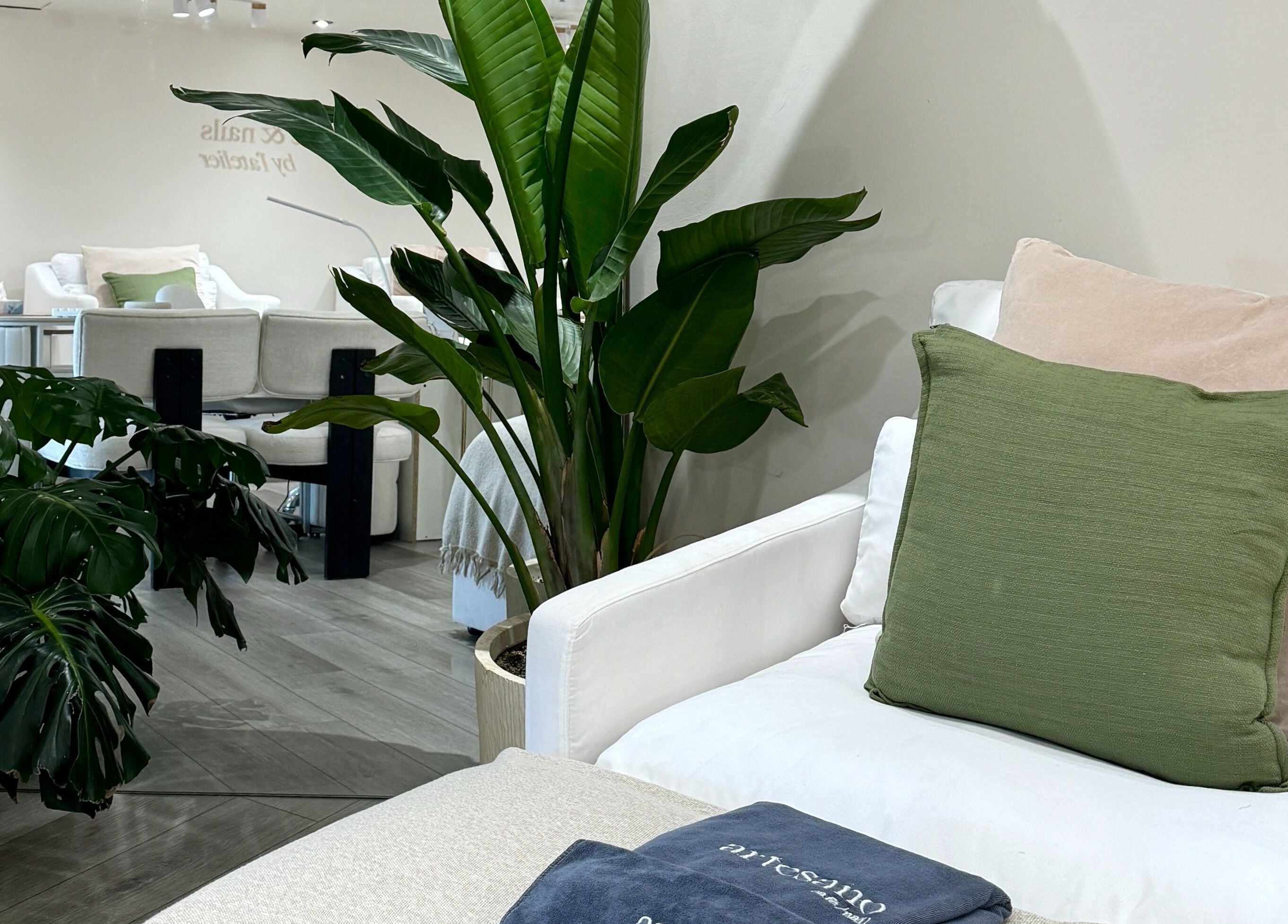Relaxing seating area with green plants at Artesano Cafe and Nail, Vancouver, British Columbia, CA.