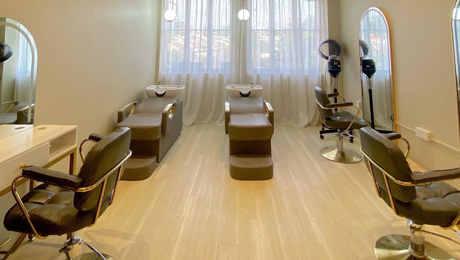 Elegant salon interior at Aurora Muslimah Salon & Spa Bangsar, Kuala Lumpur, featuring stylish chairs and mirrors.