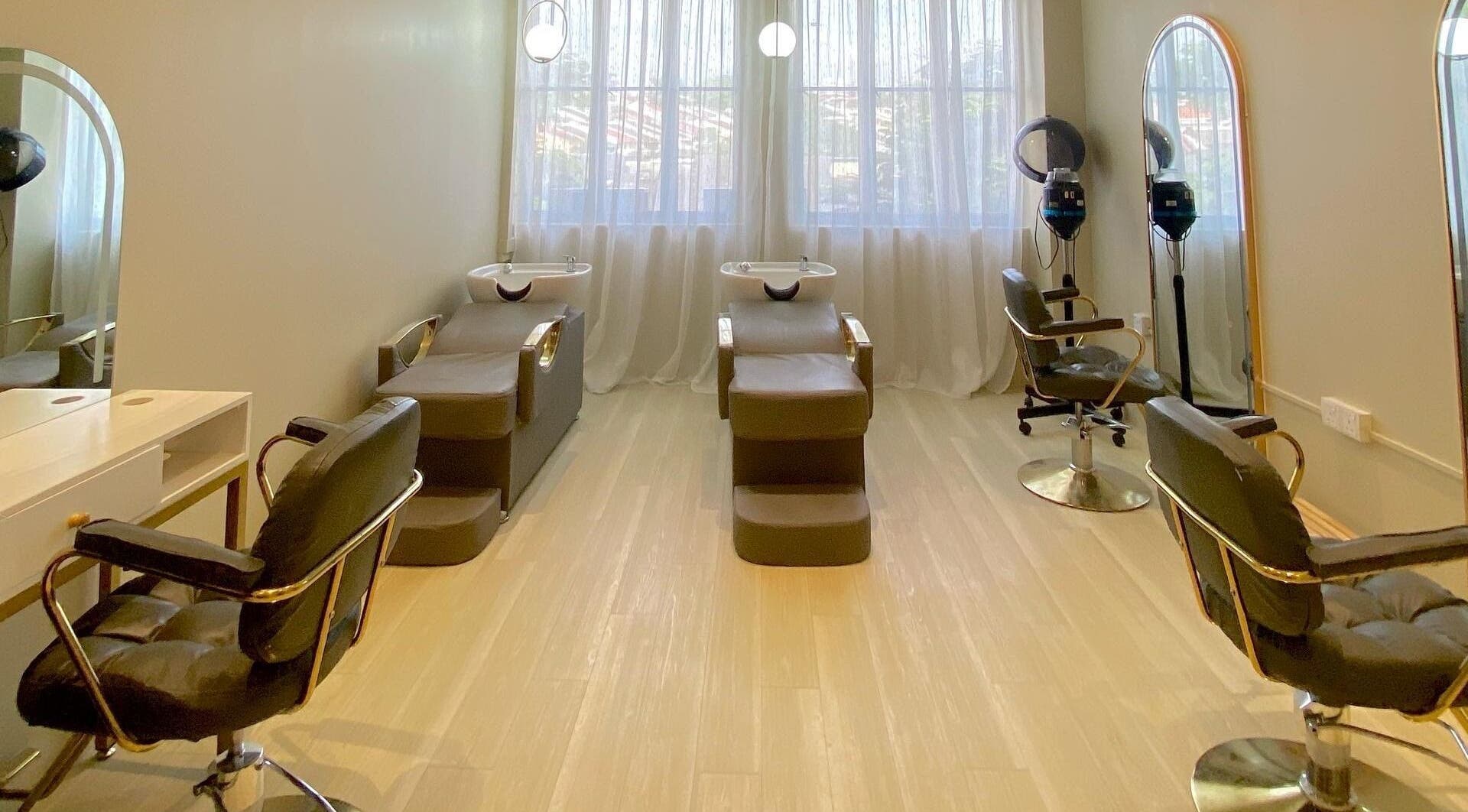 Elegant salon interior at Aurora Muslimah Salon & Spa Bangsar, Kuala Lumpur, featuring stylish chairs and mirrors.