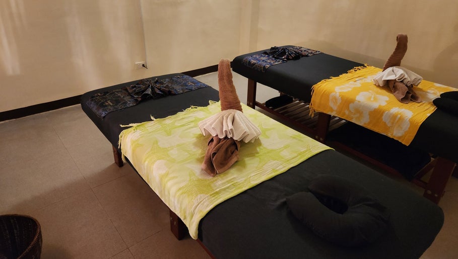 Relaxing massage beds at Kabayan Boracay, Malay, Western Visayas, PH, adorned with artfully folded towels.